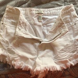 Distressed and frayed white booty shorts